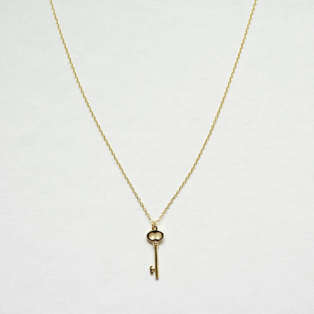 Unlock a world of success with this 14K gold sterling silver key necklace