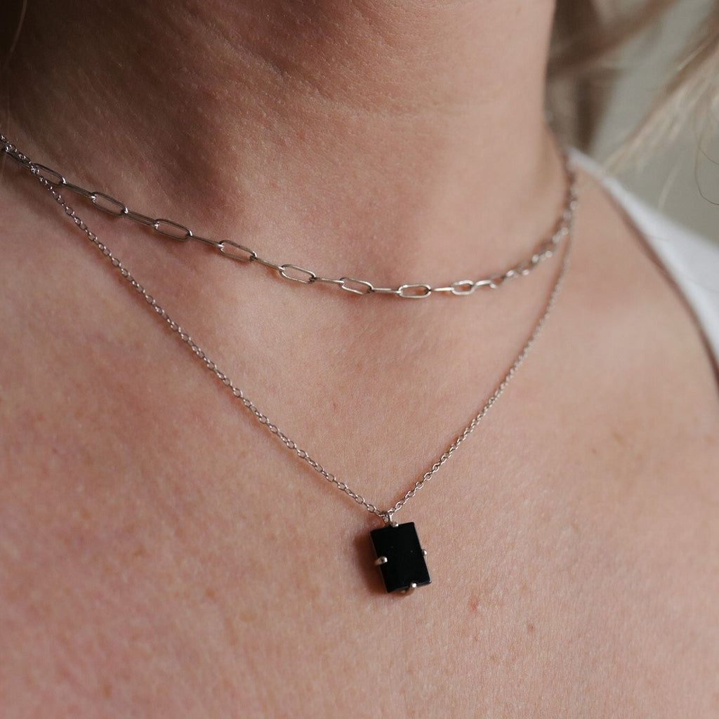 Double paperclip layered necklace with a 16-inch sterling silver chain and a glamorous black tourmaline pendant adorned in gold.