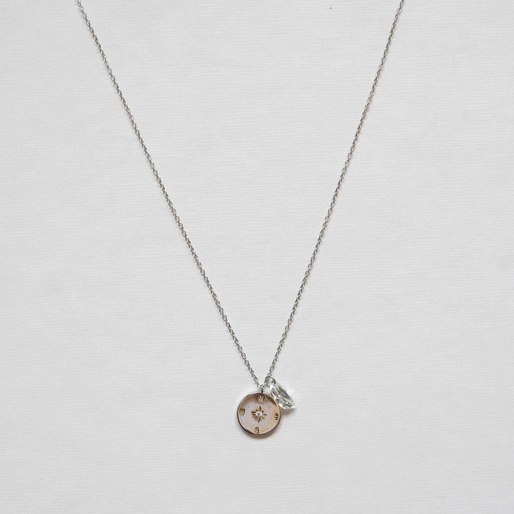 Necklace features a stunning sterling silver compass adorned with a clear quartz moon shape - rhodium plating