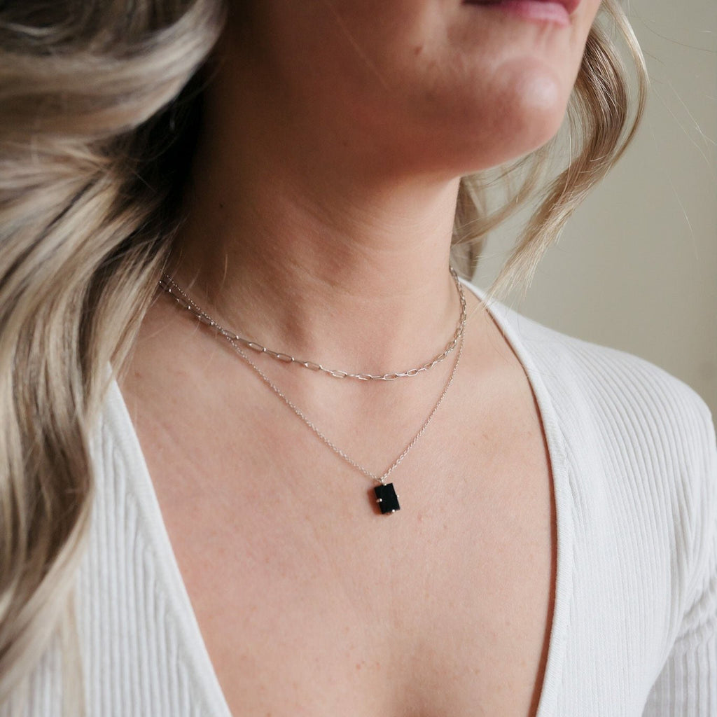 Double paperclip layered necklace with a 16-inch sterling silver chain and a glamorous black tourmaline pendant adorned in gold.